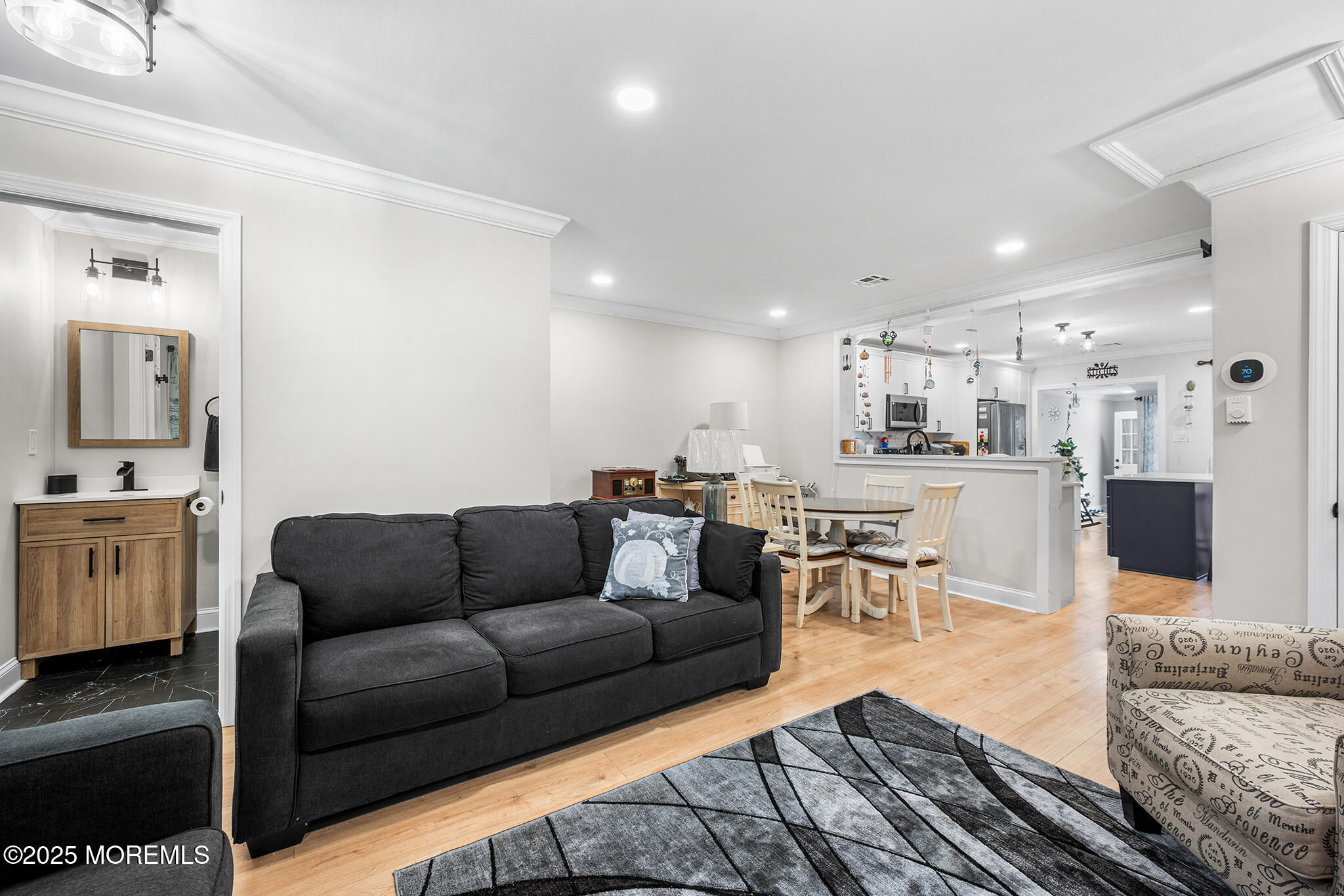 24 Calle De Elvira, Unit B Freehold, NJ 07728 - Photo 5 of 25 a living room with furniture and view of kitchen