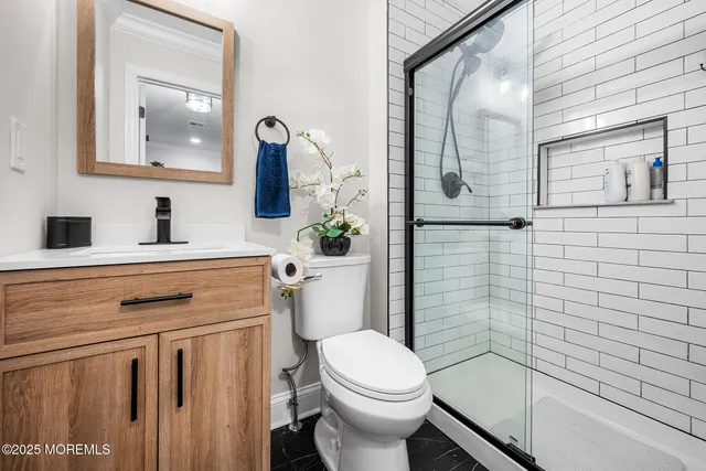 a bathroom with a sink a toilet and shower