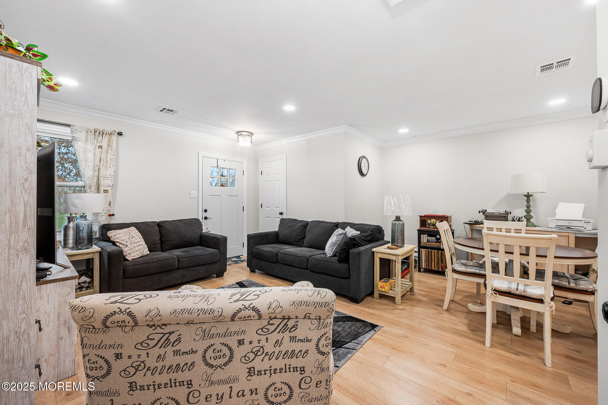 24 Calle De Elvira, Unit B Freehold, NJ 07728 - Photo 7 of 25 a living room with furniture a flat screen tv and kitchen view