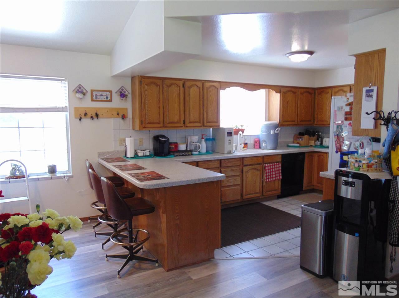 3255 Alcorn Road Fallon, NV 89406 - Photo 5 of 25 a kitchen with a sink a cabinets and wooden floor