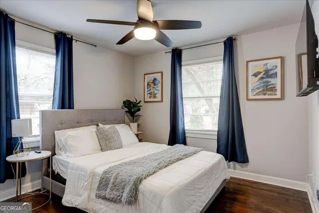 a bedroom with a large bed and a window