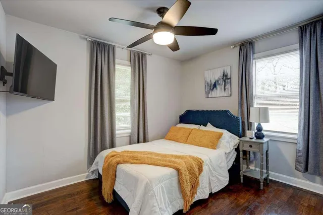 a bedroom with a large bed and a tv