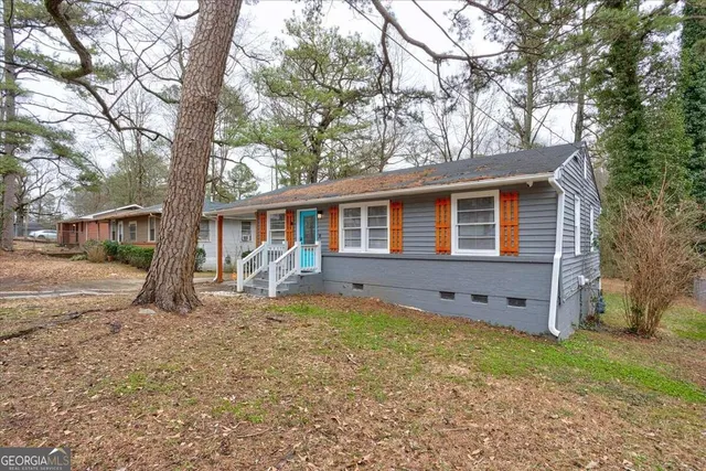 a house that has a tree in front of the house