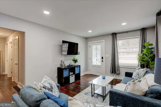 a living room with furniture and a flat screen tv