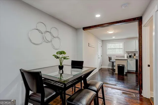 a view of a dining room with furniture wooden floor and a chandelier