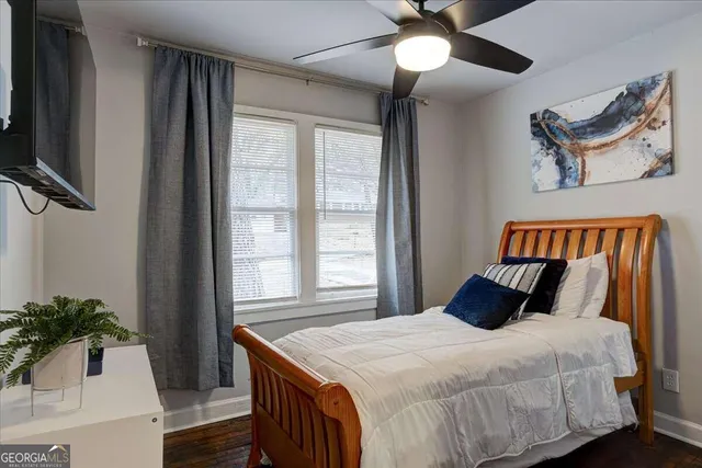 a bedroom with a bed and a potted plant