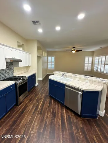 a large kitchen with kitchen island a sink stainless steel appliances and cabinets