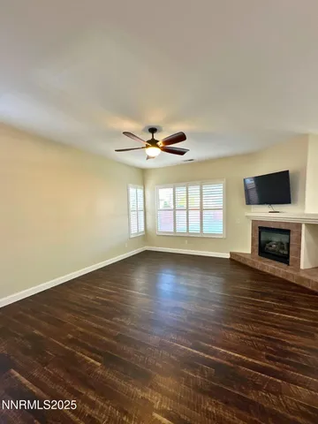 wooden floor in an empty room with a fireplace