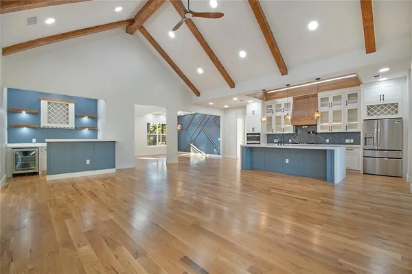 a large kitchen with stainless steel appliances granite countertop a stove and cabinets