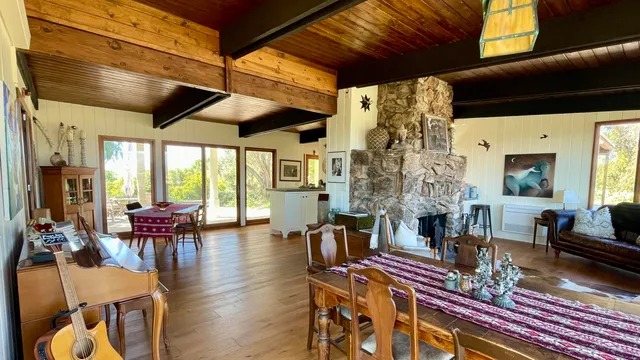 a living room with fireplace furniture and a large window