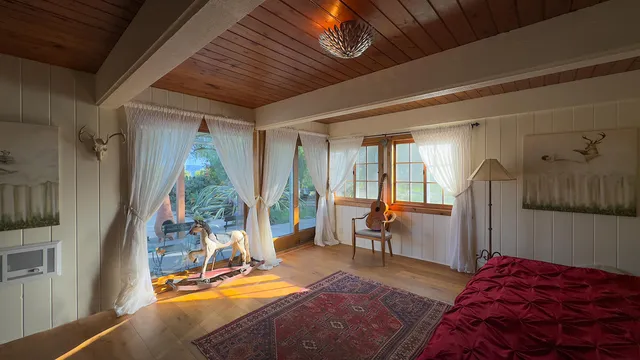 a bed sitting in a bedroom next to a window