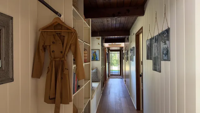 a view of hallway with wooden floor