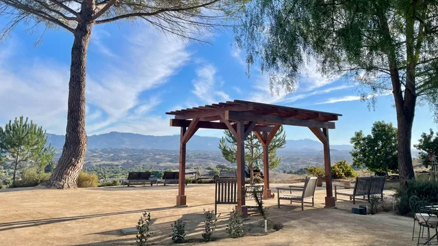 an aerial view of a houses with a yard and lake view