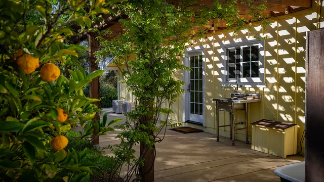 a living room with furniture a large window and wood floor