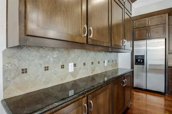 a kitchen with granite countertop a sink and stainless steel appliances