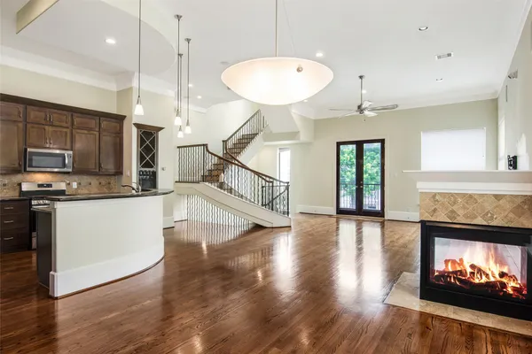 a kitchen with stainless steel appliances granite countertop a refrigerator a stove and a wooden floors