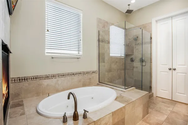 a bathroom with a bathtub and shower
