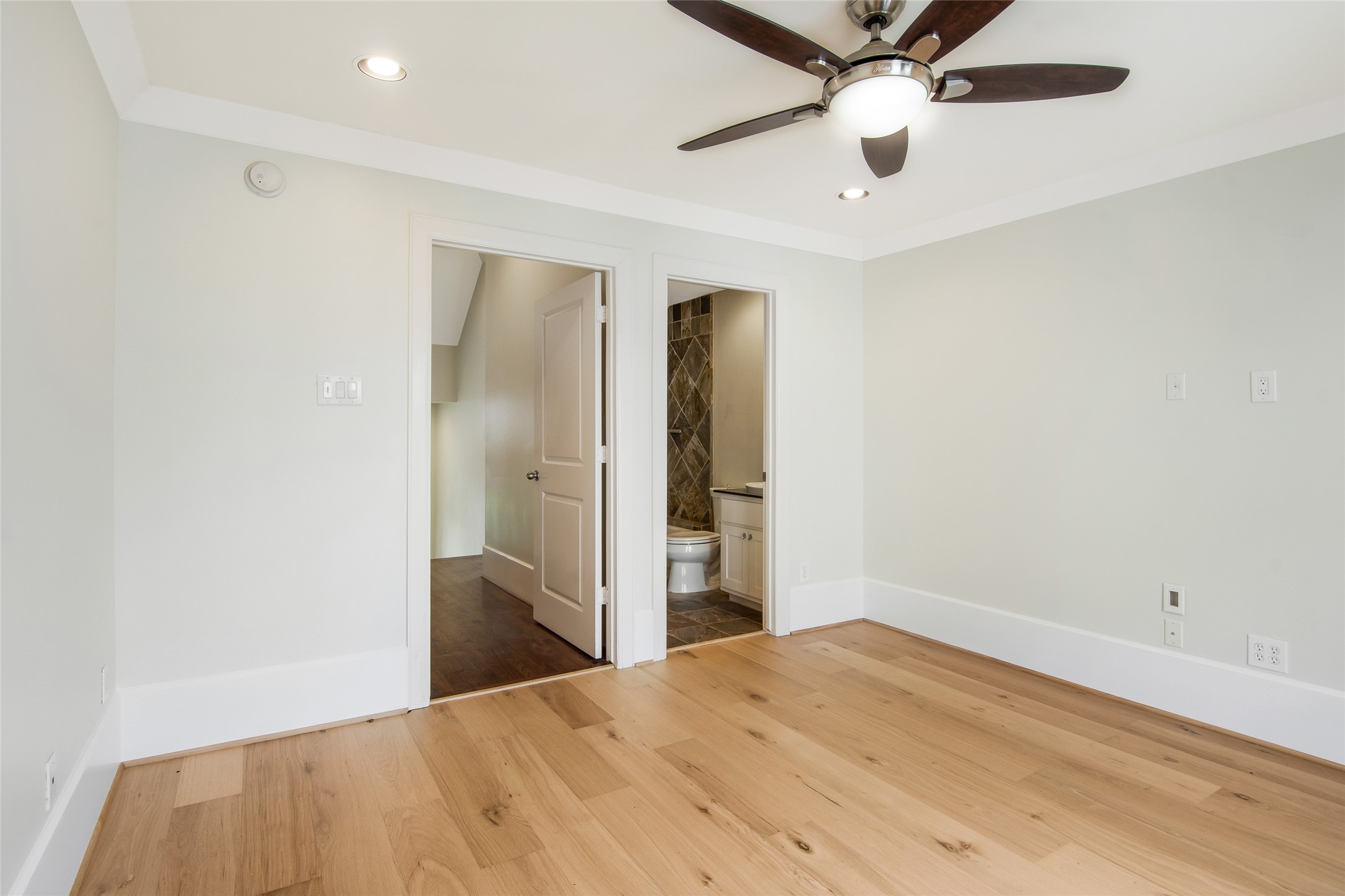 5505 Rose Street Houston, TX 77007 - Photo 25 of 35 a bedroom with a bed and a chandelier