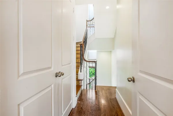 a view of a hallway with wooden floor and entryway