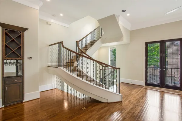 a view of entryway and hall with wooden floor
