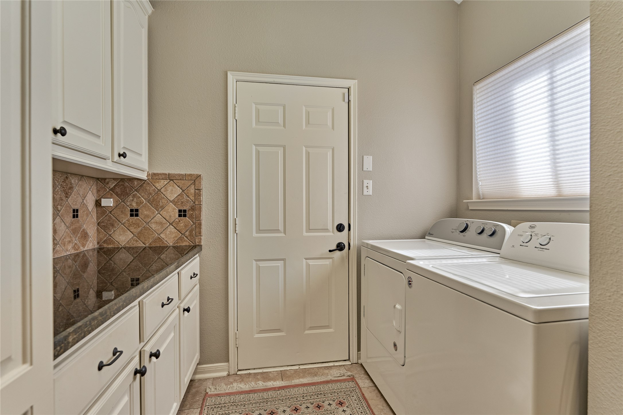 197 Monterrey Road East Montgomery, TX 77356 - Photo 19 of 50 The laundry room offers ample storage, complemented by two additional pantries in the home, plus a separate pantry in the kitchen for exceptional organization and convenience.