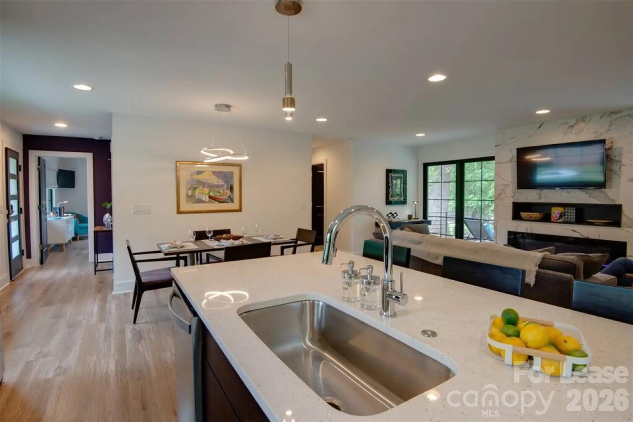 3945 Rockfern Road, Unit A Charlotte, NC 28217 - Photo 16 of 38 a kitchen with a sink a counter top space and living room view