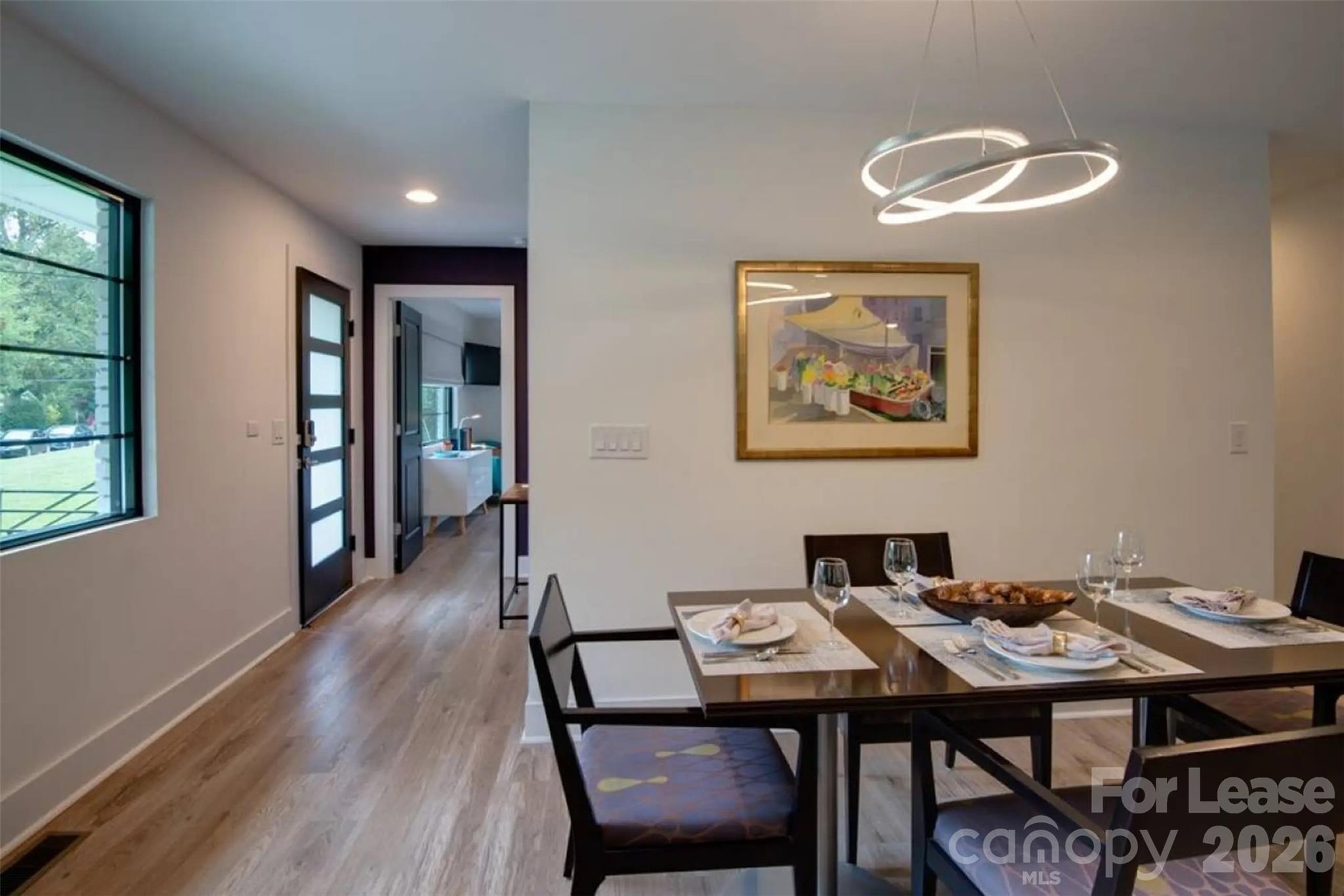 3945 Rockfern Road, Unit A Charlotte, NC 28217 - Photo 18 of 38 a view of a dining room with furniture and wooden floor