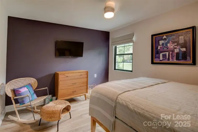 a bedroom with a bed and a television