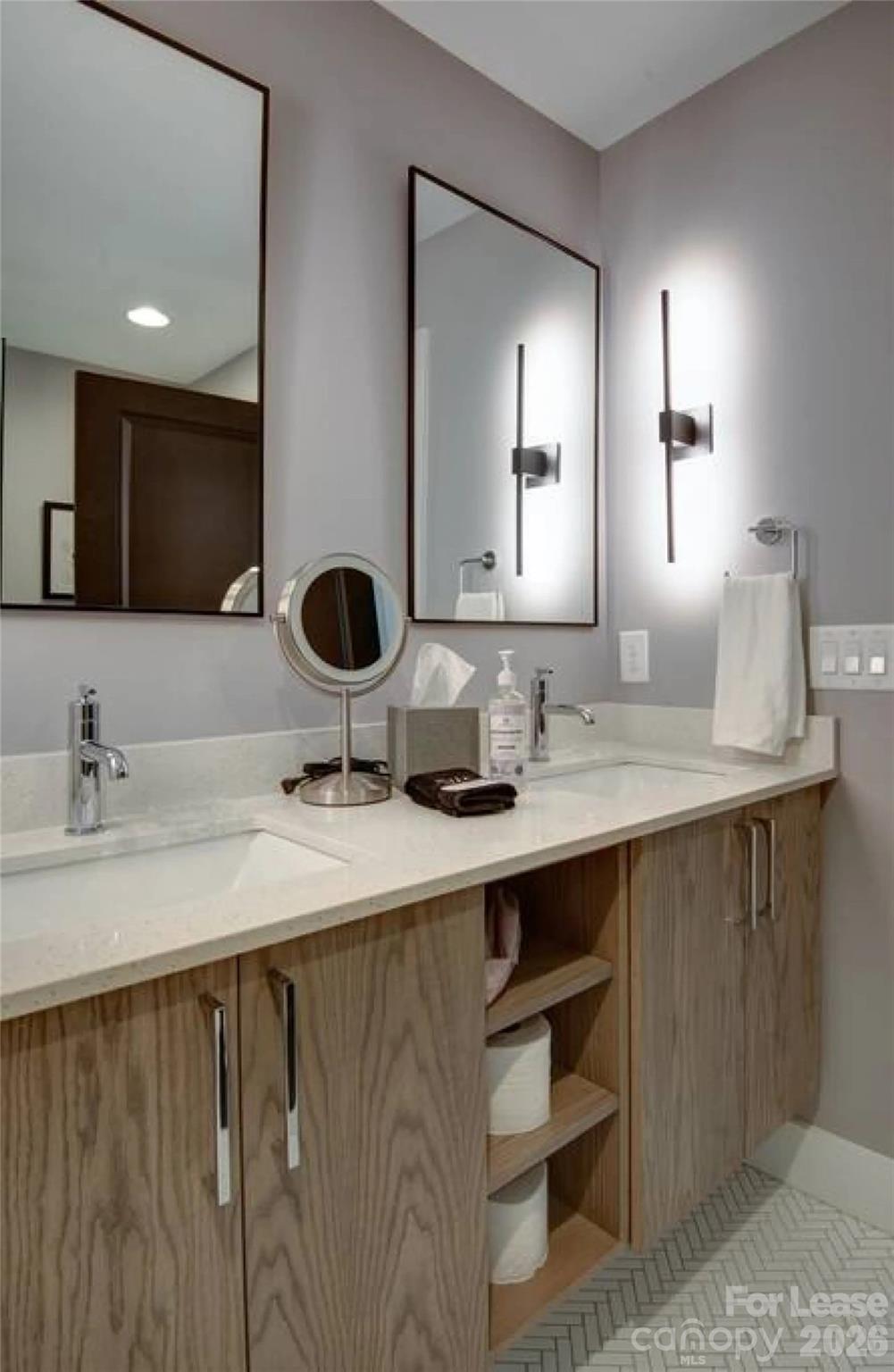 3945 Rockfern Road, Unit A Charlotte, NC 28217 - Photo 26 of 38 a bathroom with a double vanity sink a mirror and vanity