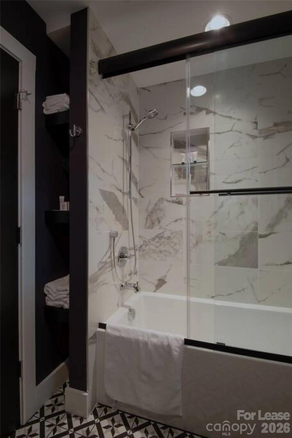 3945 Rockfern Road, Unit A Charlotte, NC 28217 - Photo 28 of 38 a bathroom with a bathtub and a shower