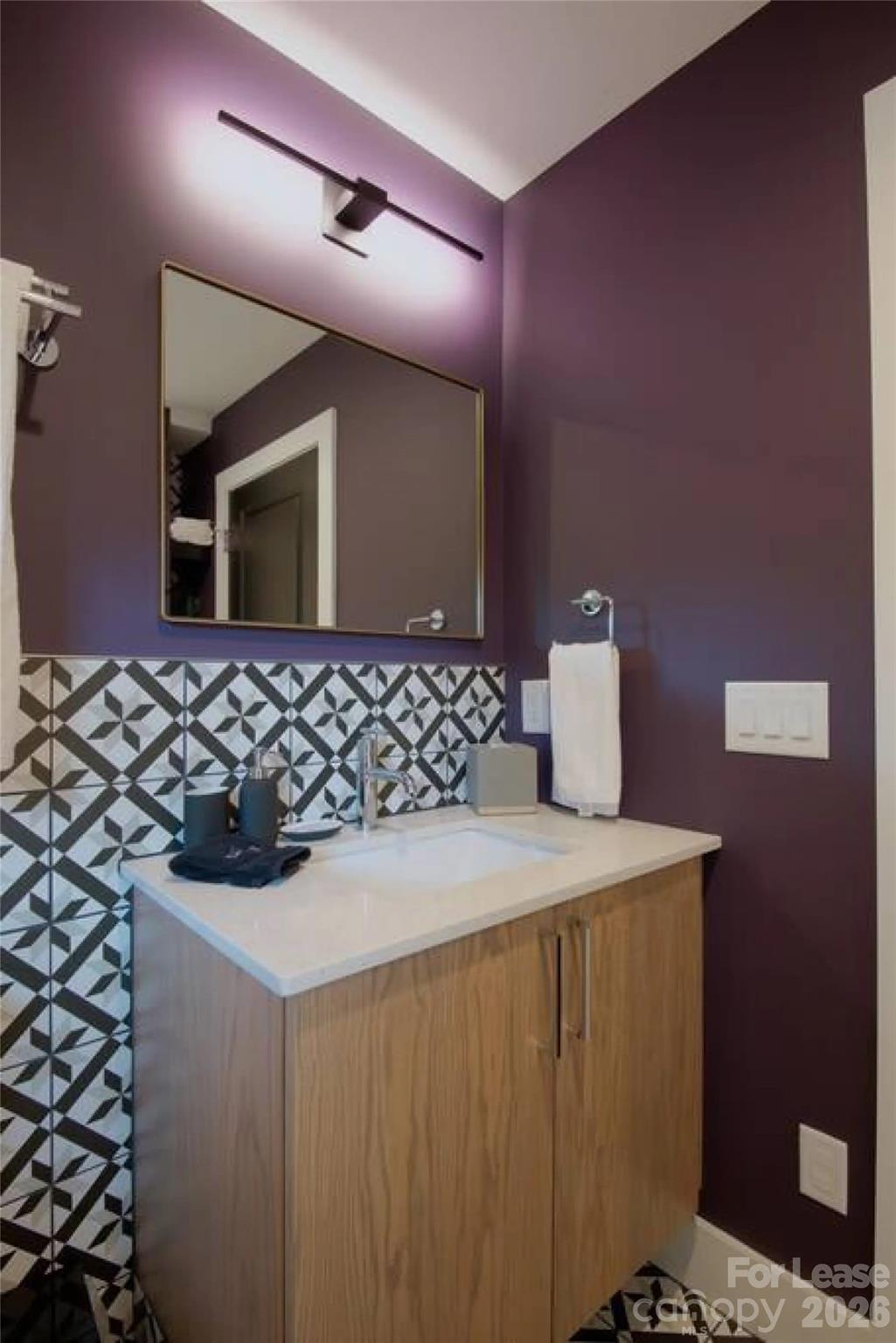 3945 Rockfern Road, Unit A Charlotte, NC 28217 - Photo 29 of 38 a bathroom with a sink and a mirror