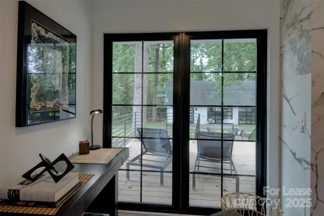 a view of a workspace with furniture and window