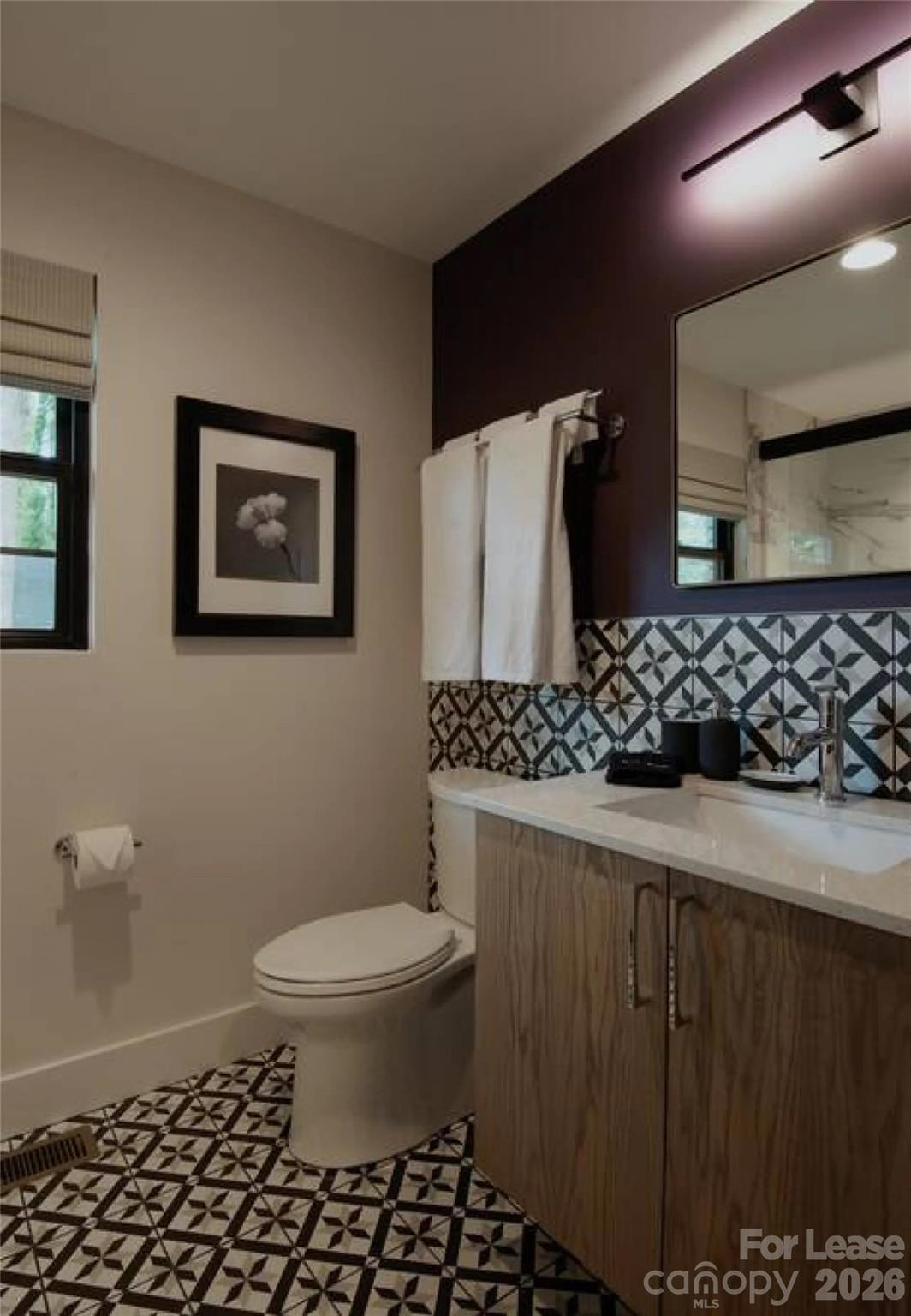 3945 Rockfern Road, Unit A Charlotte, NC 28217 - Photo 30 of 38 a bathroom with a sink toilet and shower