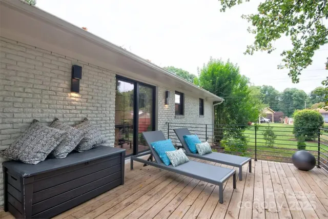 a view of a patio with couches chairs and a potted plant