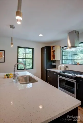 a kitchen with a stove a sink and a refrigerator