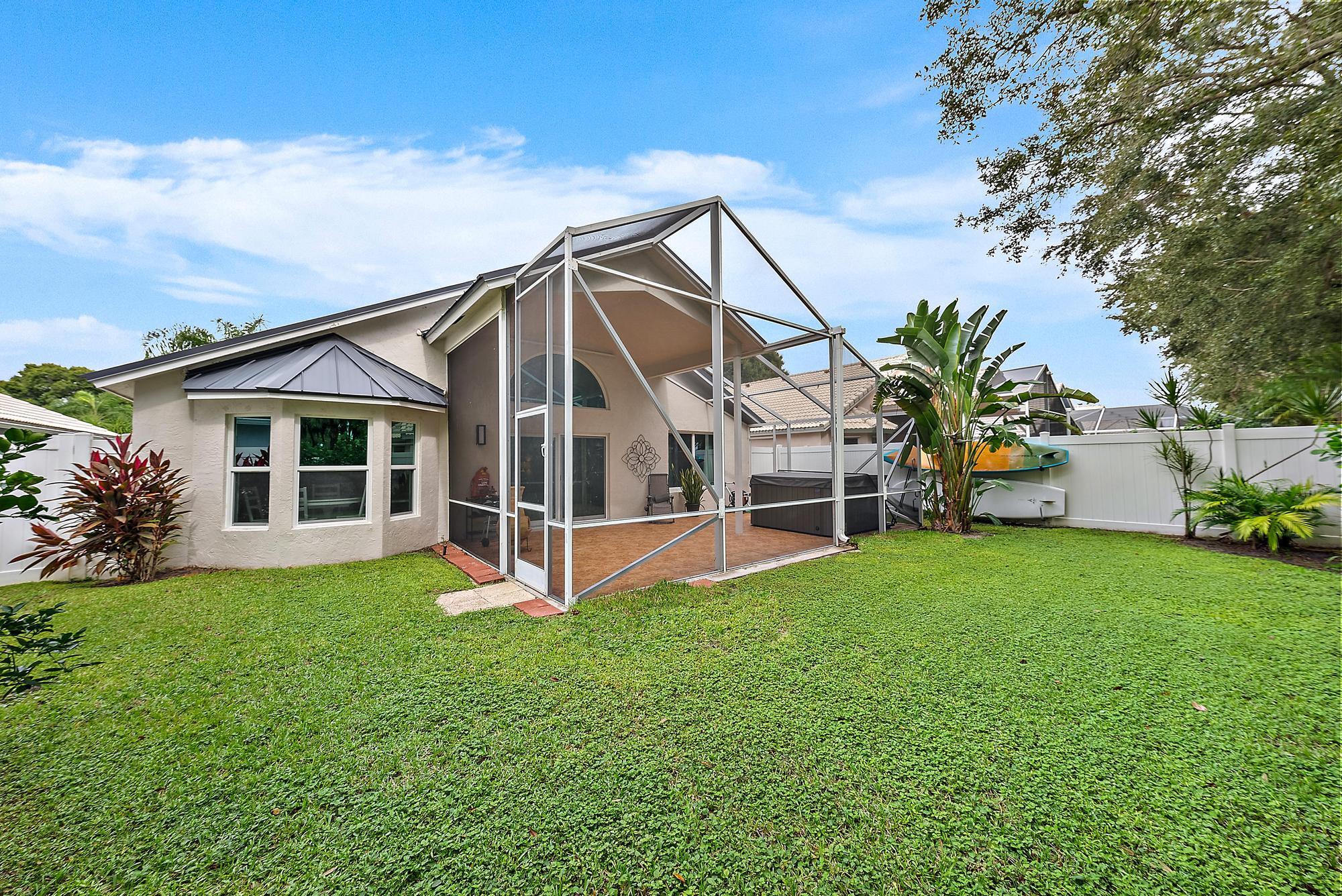 112 Spoonbill Court Jupiter, FL 33458 - Photo 2 of 28 a view of a house with backyard porch and garden