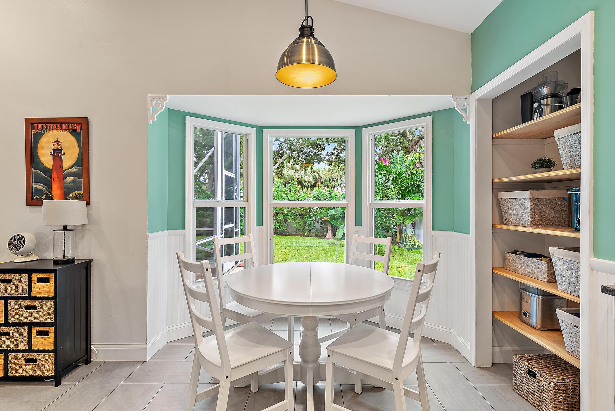 112 Spoonbill Court Jupiter, FL 33458 - Photo 3 of 28 a dining room with furniture and window