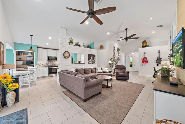 a living room with furniture and kitchen view