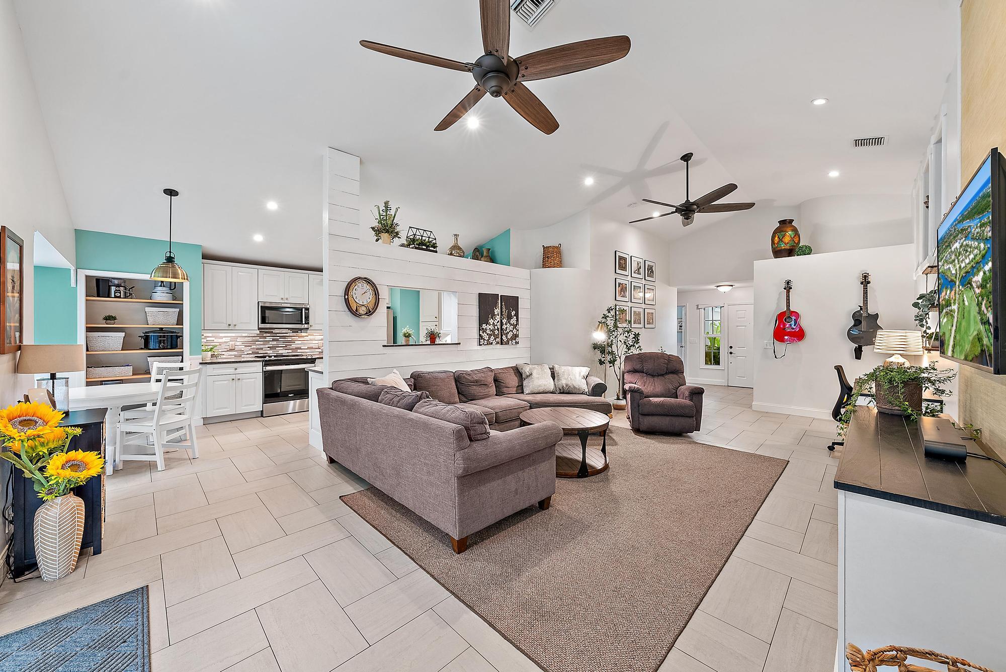 112 Spoonbill Court Jupiter, FL 33458 - Photo 7 of 28 a living room with furniture and kitchen view
