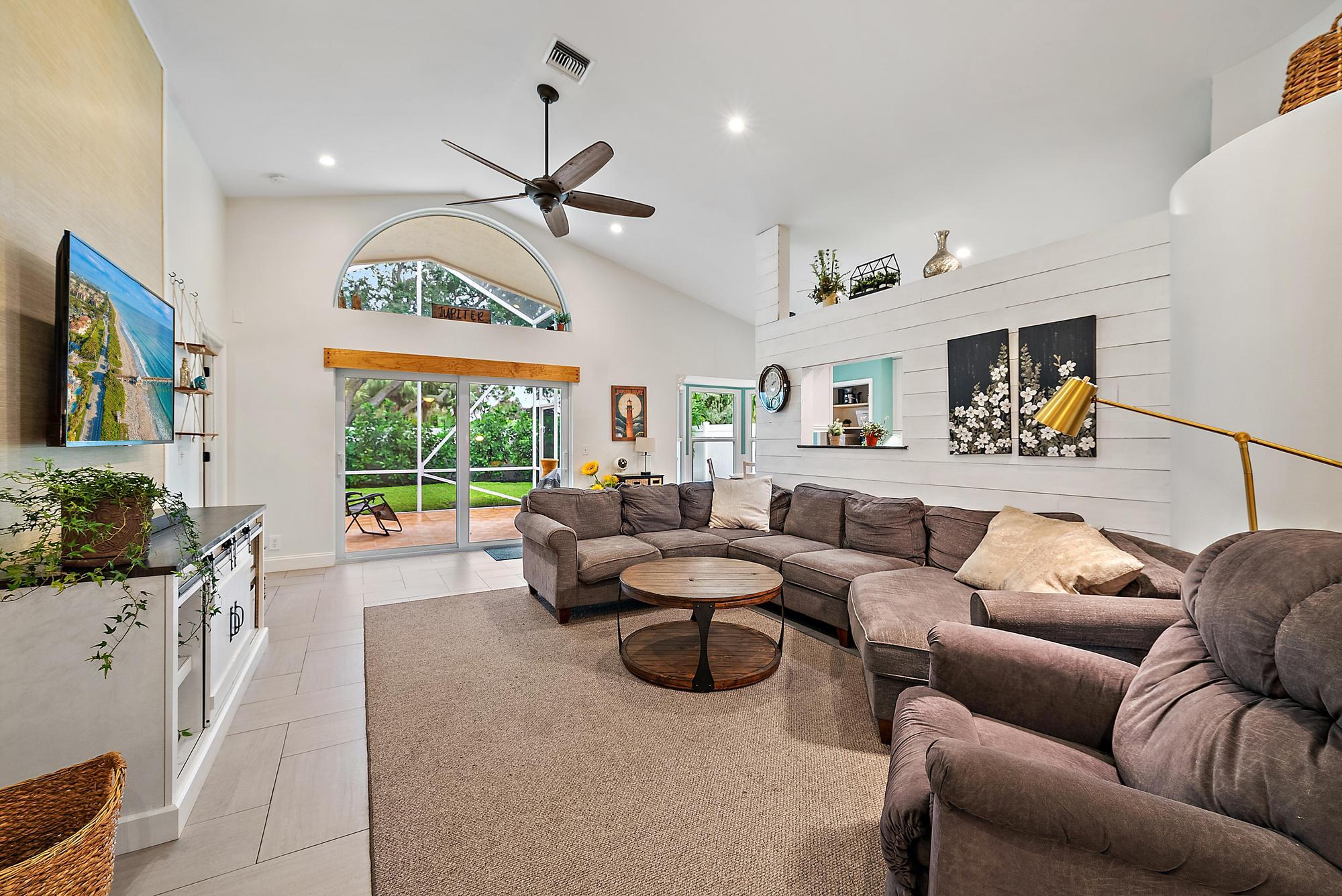 112 Spoonbill Court Jupiter, FL 33458 - Photo 8 of 28 a living room with furniture fireplace and a large window