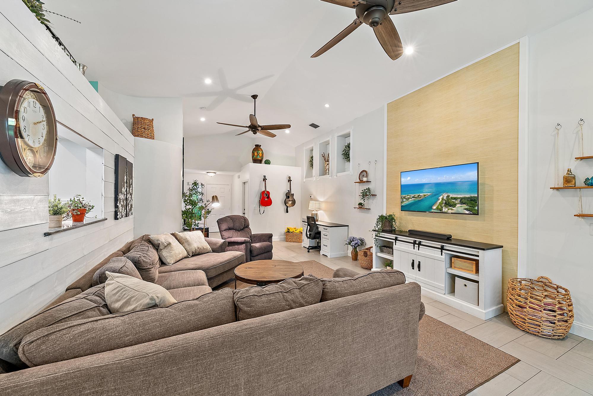 112 Spoonbill Court Jupiter, FL 33458 - Photo 10 of 28 a living room with furniture and a flat screen tv