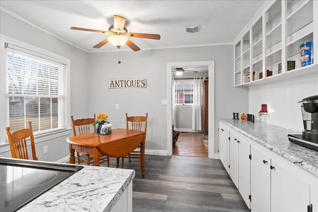 a kitchen with granite countertop a sink stove and refrigerator