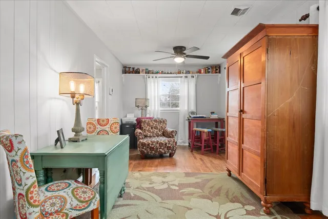 a view of a hallway with wooden floor and entryway
