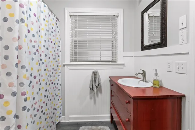 a bathroom with a sink and mirror
