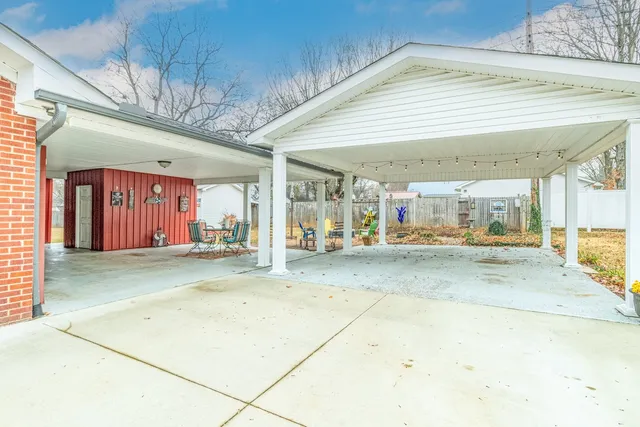 a view of a room with kitchen area and chandelier