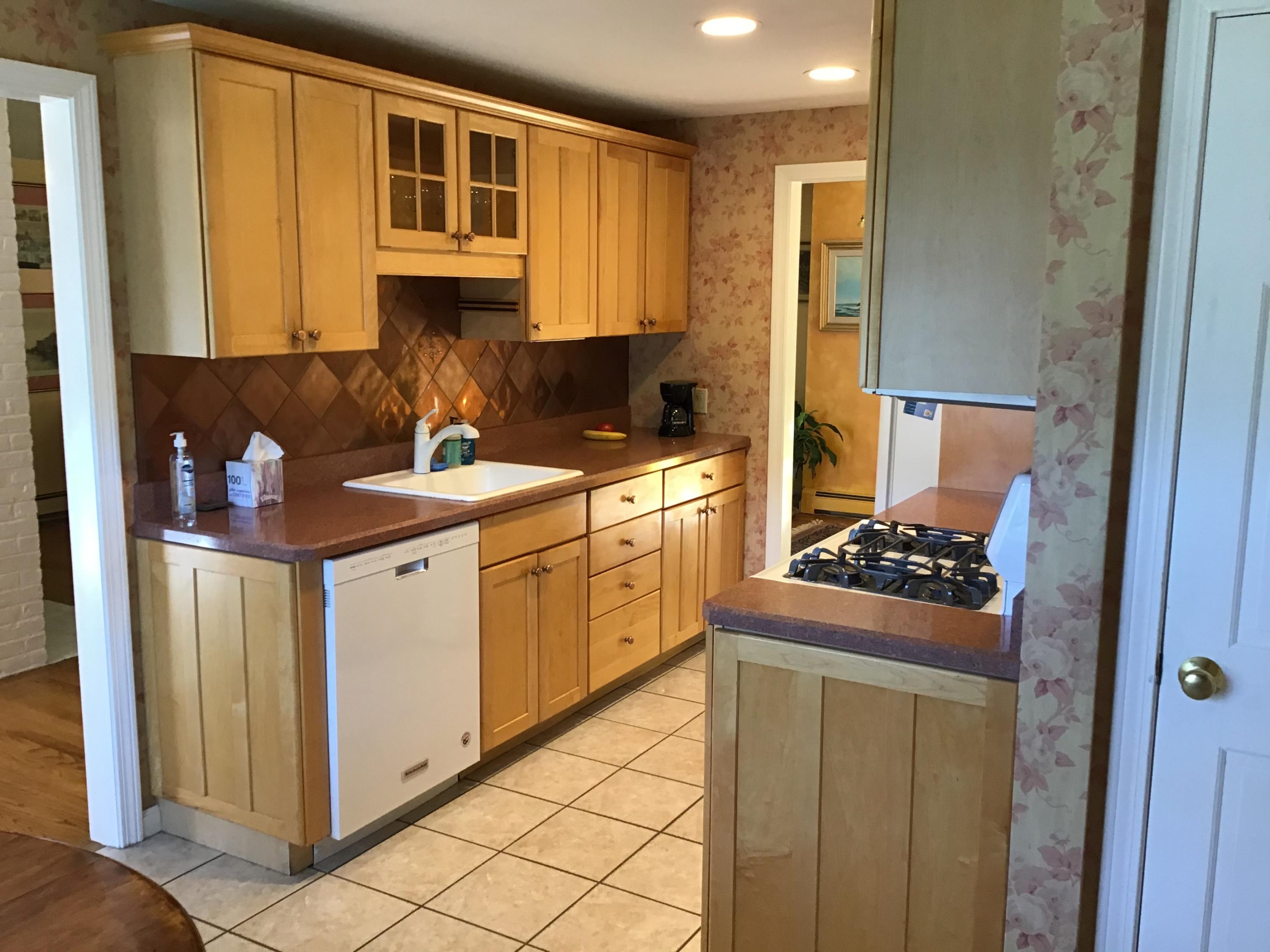 114 Sullivan Road West Yarmouth, MA 02673 - Photo 19 of 41 a kitchen with a stove cabinets and a refrigerator