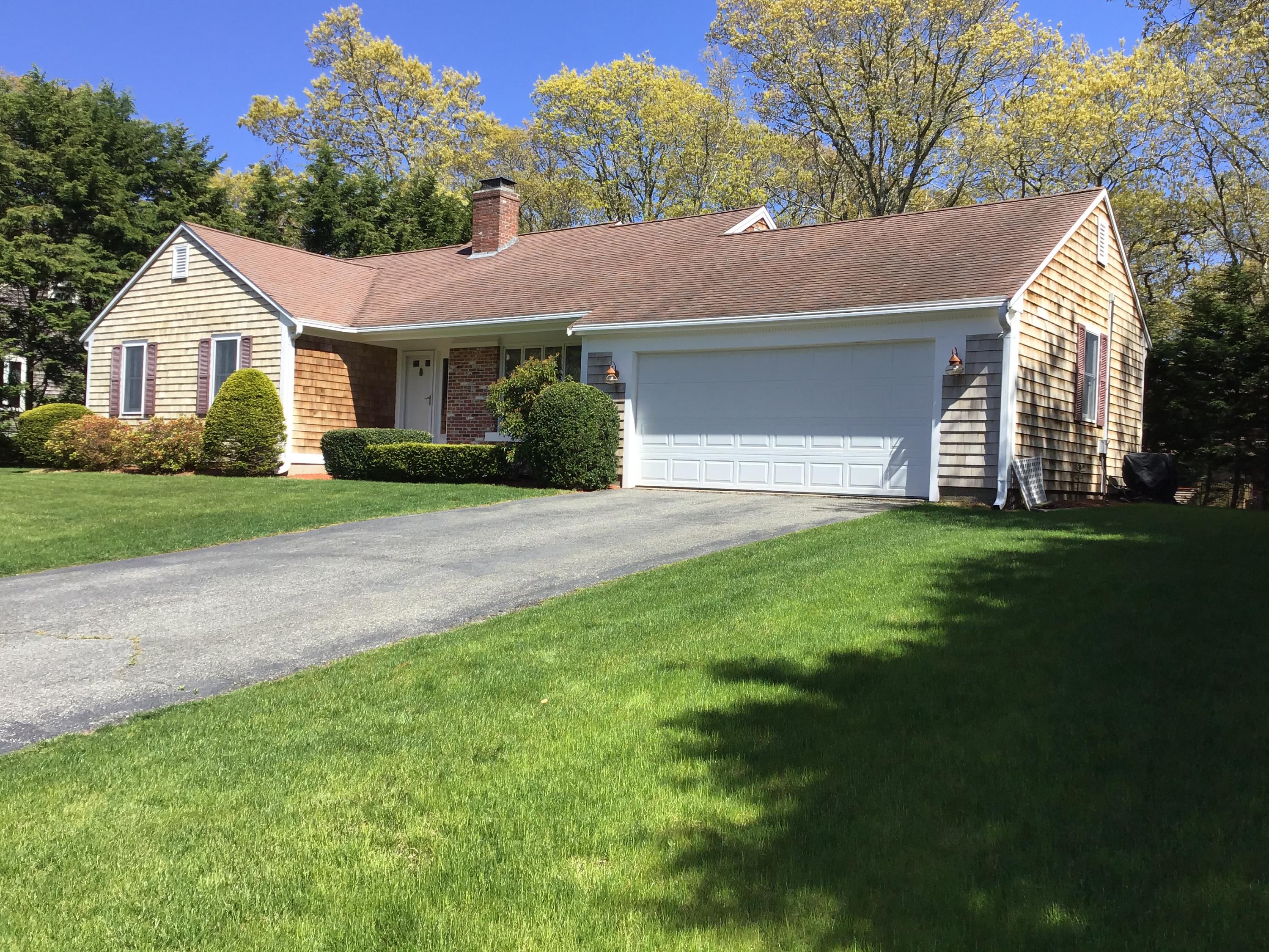 114 Sullivan Road West Yarmouth, MA 02673 - Photo 2 of 41 a front view of a house with a garden and yard