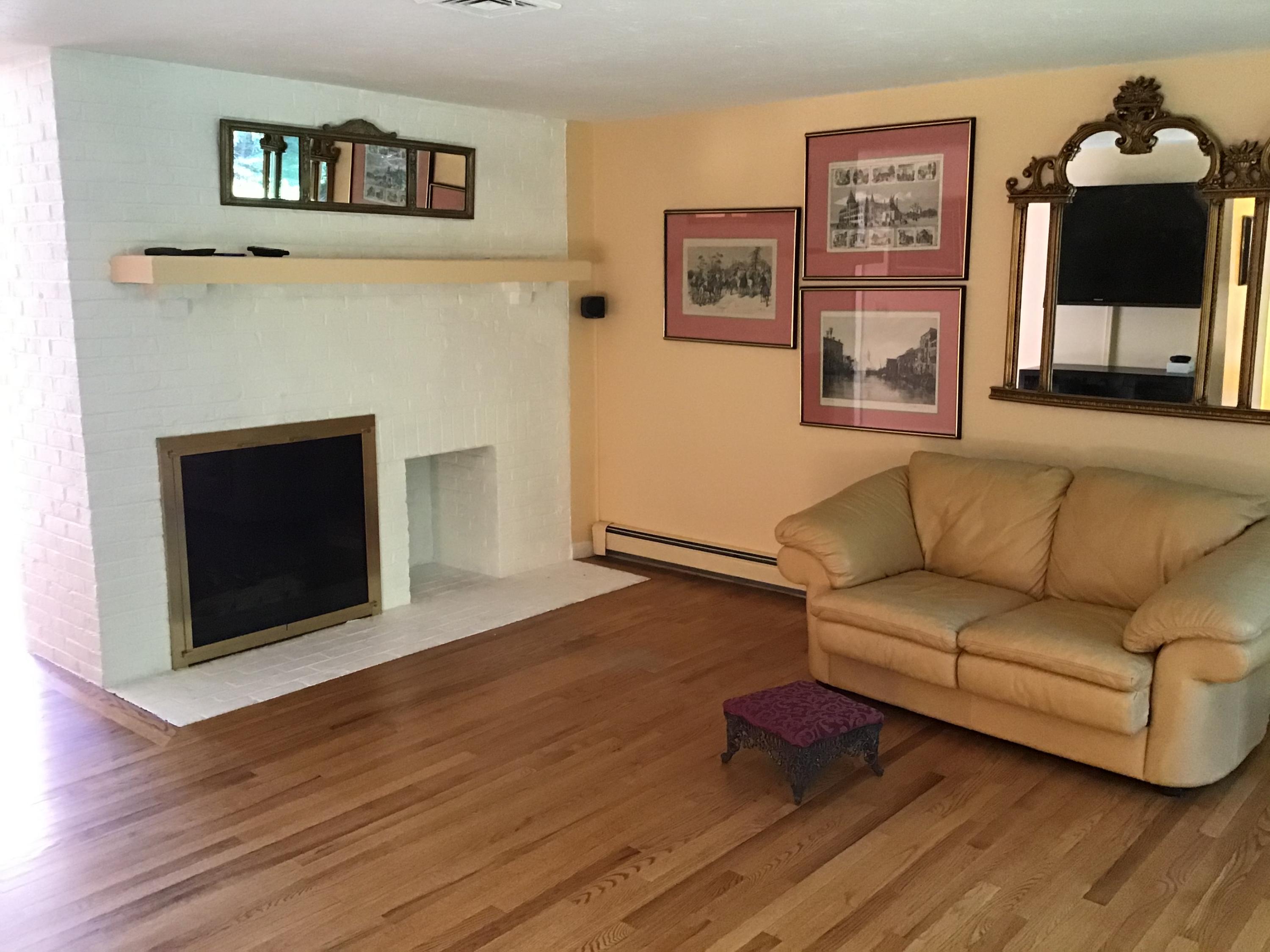 114 Sullivan Road West Yarmouth, MA 02673 - Photo 21 of 41 a living room with furniture and a fireplace
