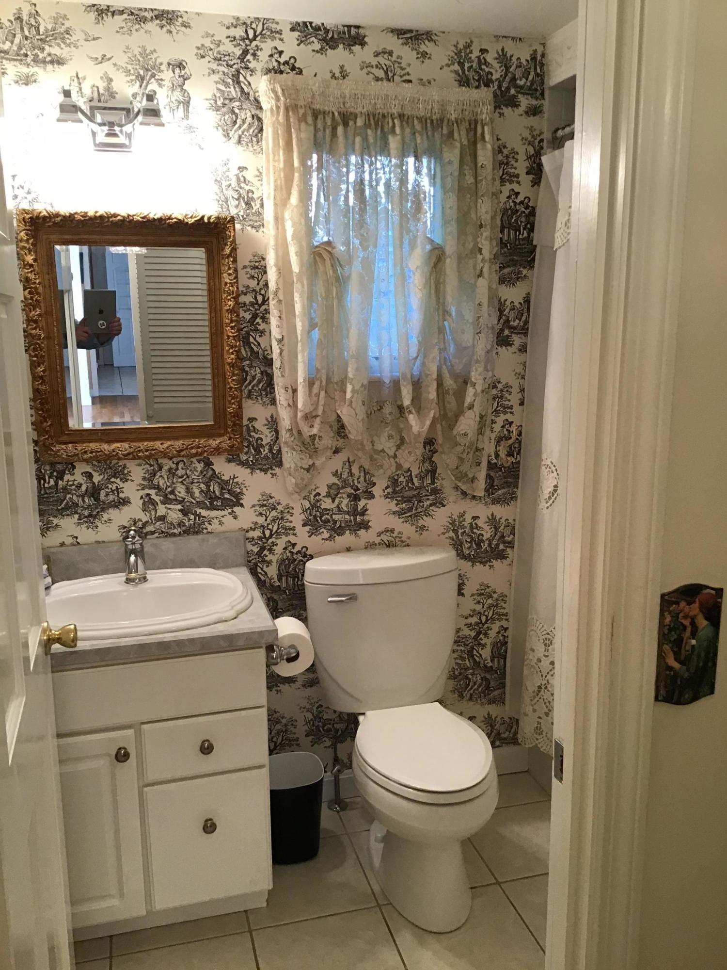 114 Sullivan Road West Yarmouth, MA 02673 - Photo 29 of 41 a bathroom with a toilet sink and mirror