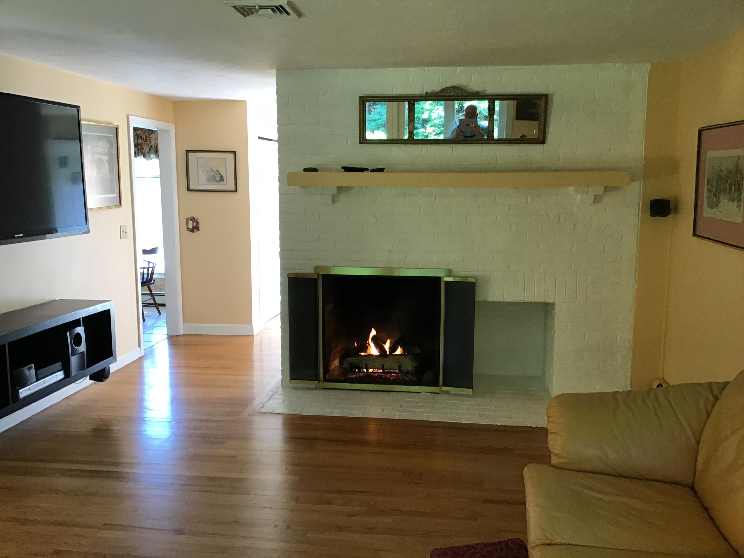 114 Sullivan Road West Yarmouth, MA 02673 - Photo 35 of 41 a living room with furniture and a fireplace